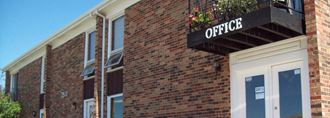 a brick building with a sign on top of it