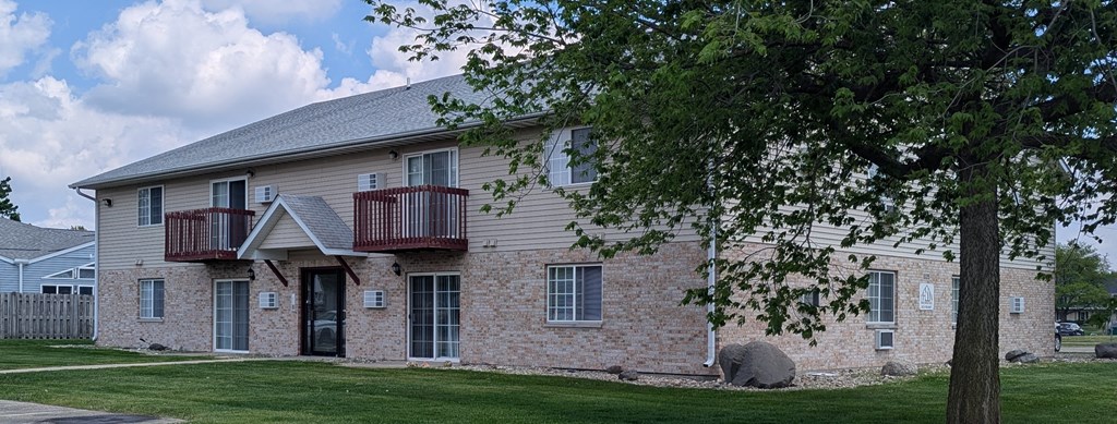 A two-story building with a balcony on the second floor.