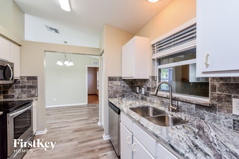 A kitchen with a sink and a window.