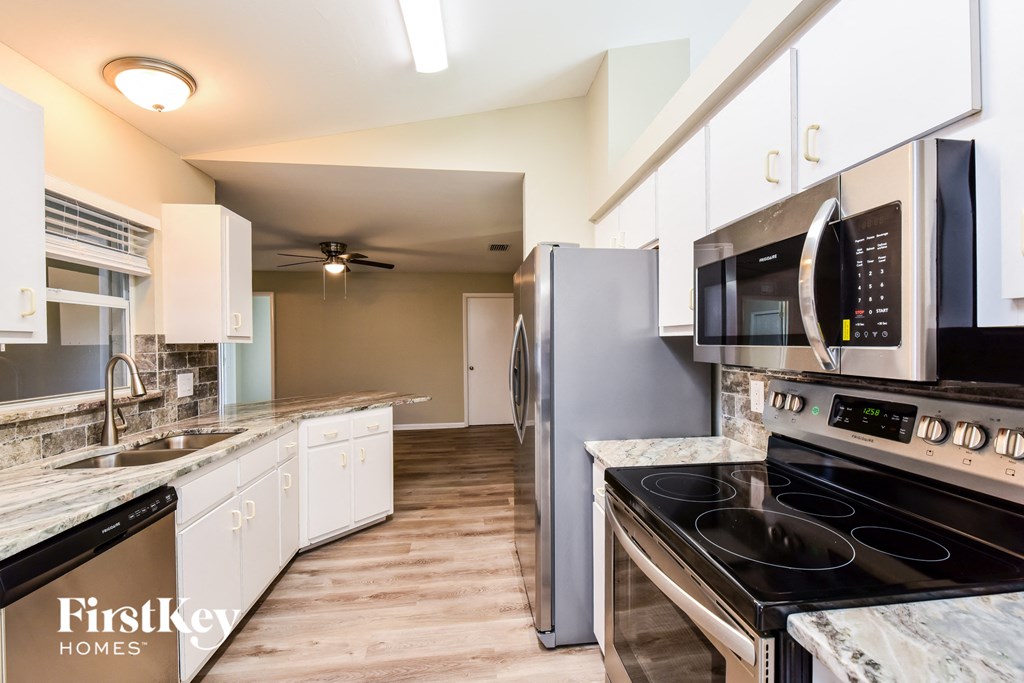 A kitchen with a stove top oven and a microwave.