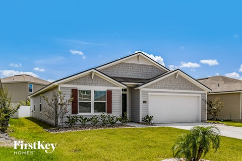 A house with a garage and a driveway is for sale.