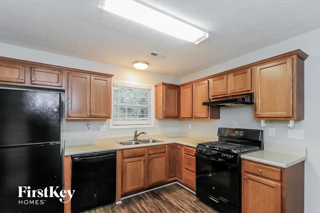 a kitchen with black appliances and wooden cabinets