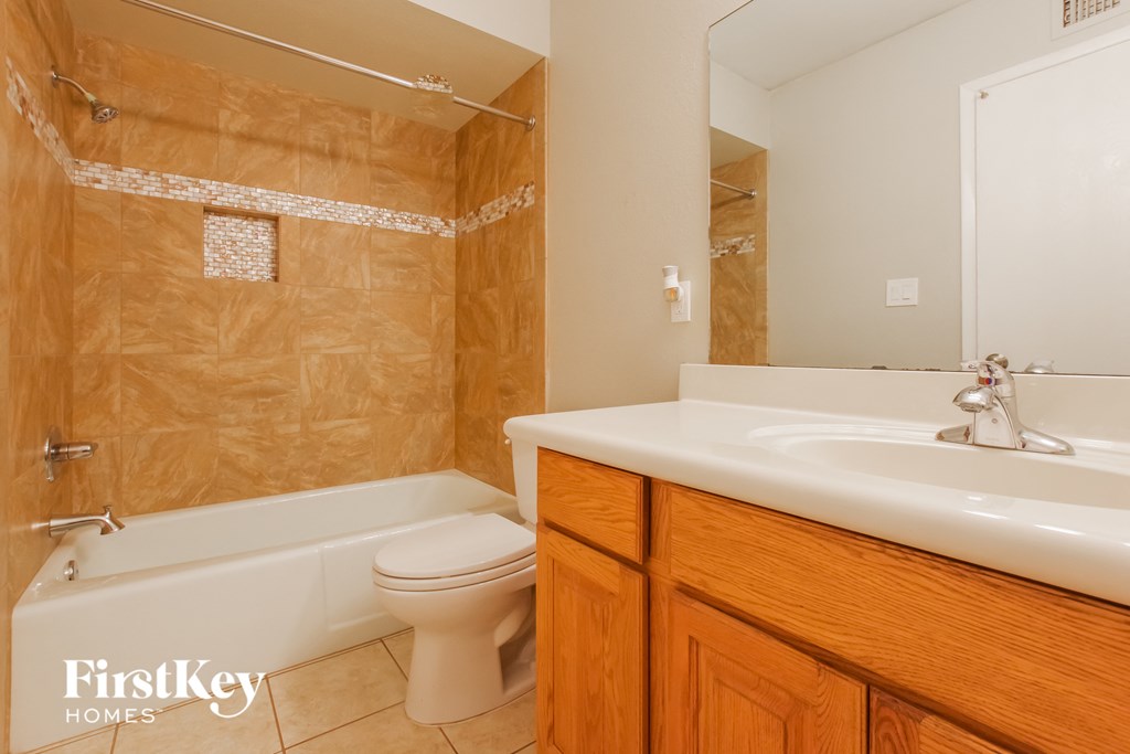 a bathroom with a toilet and a sink and a tub