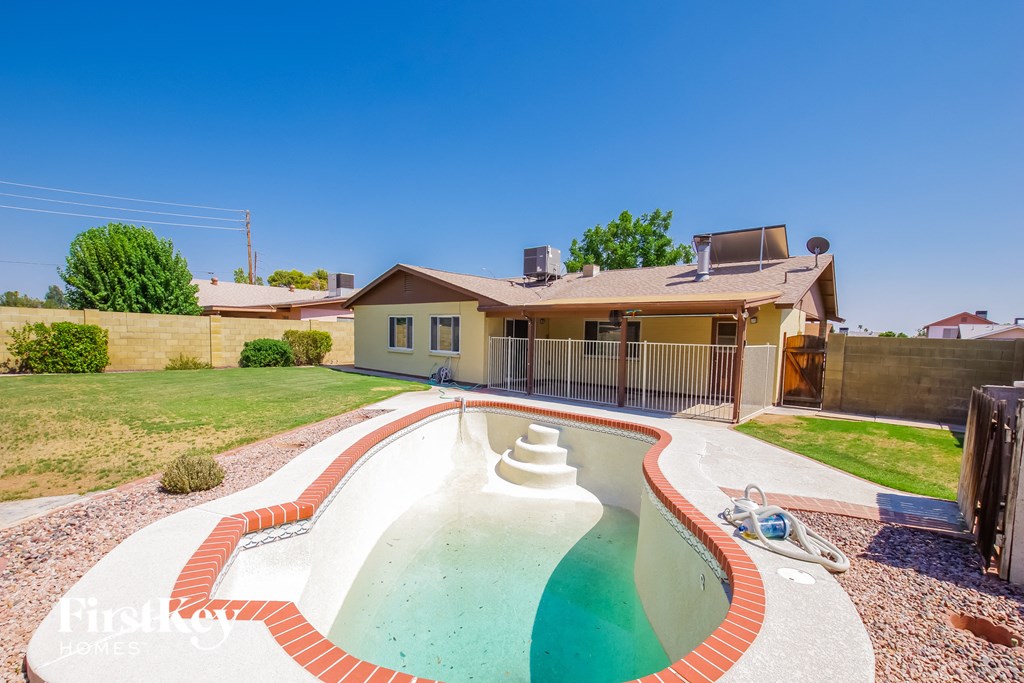 a backyard with a pool and a house