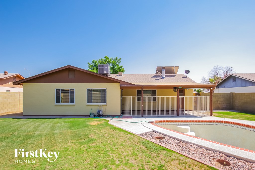 a backyard with a pool and a house