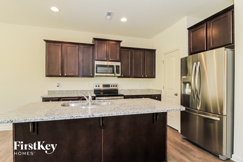 a kitchen with stainless steel appliances and granite counter tops
