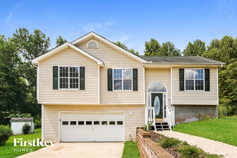 a tan house with a white garage door