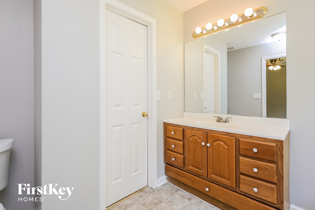 a bathroom with a vanity and a mirror and a toilet