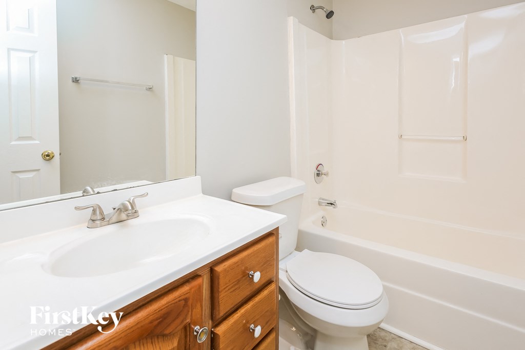 a bathroom with a sink toilet and a shower