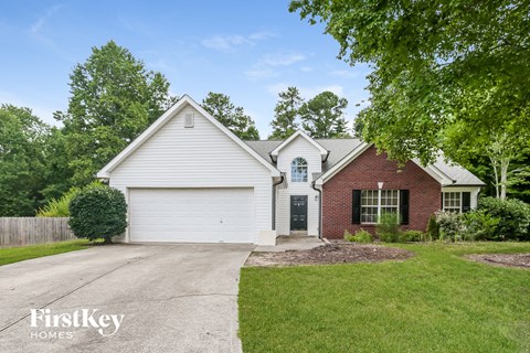a white and red brick house with white siding and a driveway