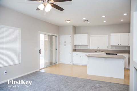 A spacious kitchen with white cabinets and a central island.