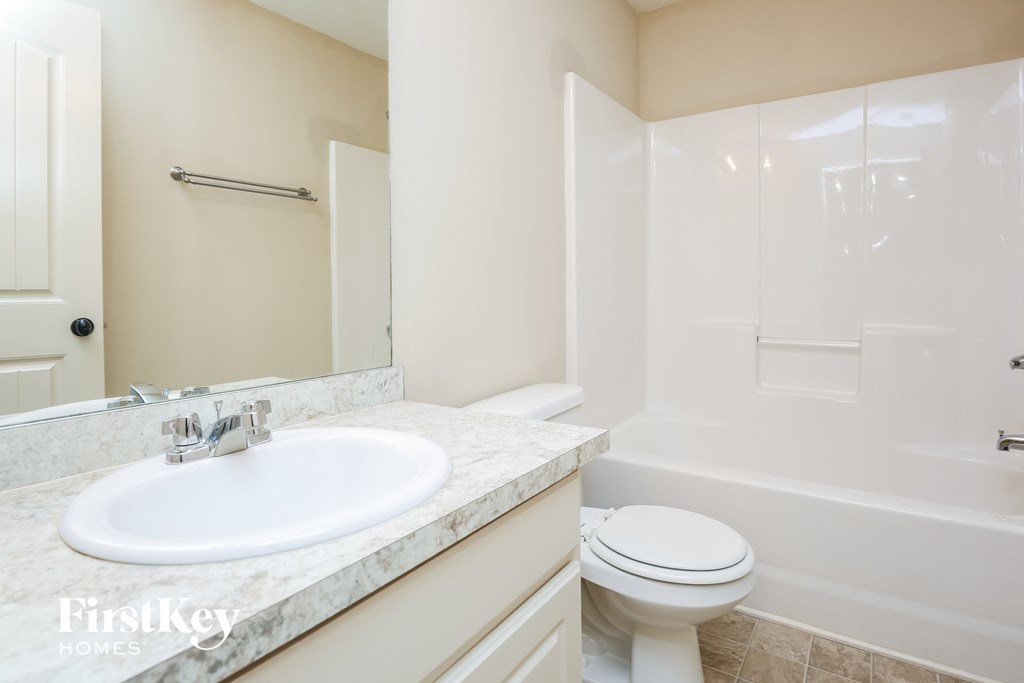 a bathroom with a sink toilet and a shower