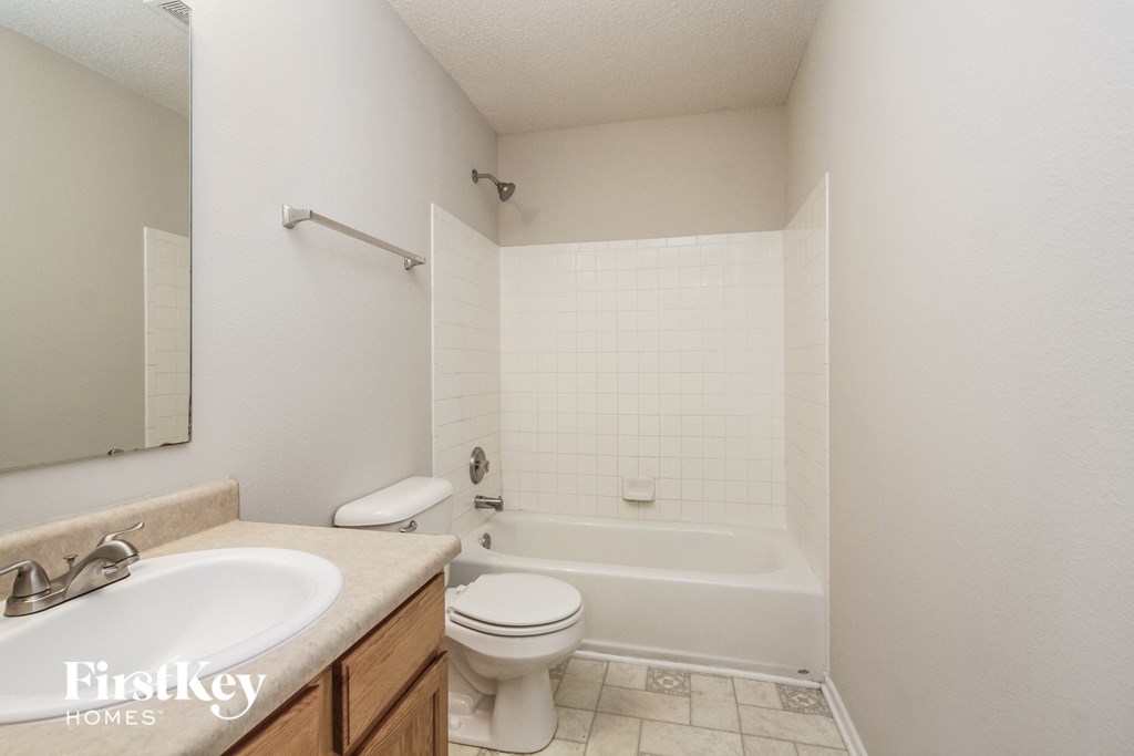 a bathroom with a sink toilet and a bath tub