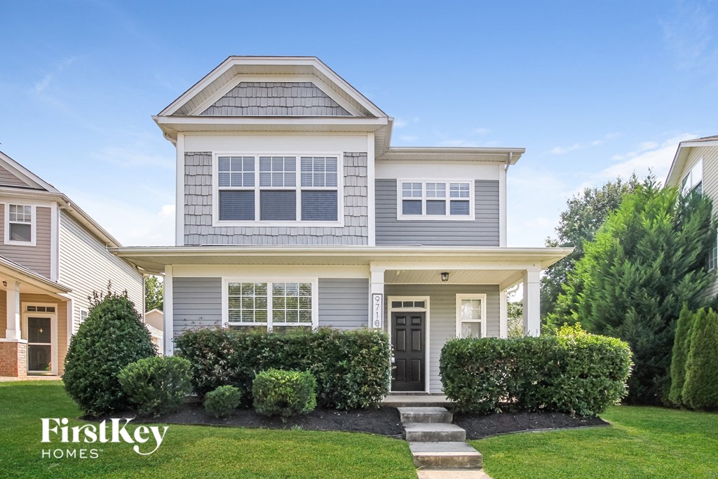a blue house with a lawn in front of it