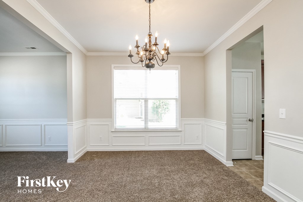 a dining room with a chandelier and a window