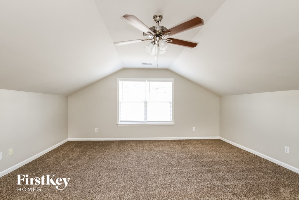 the master bedroom is spacious and has a ceiling fan