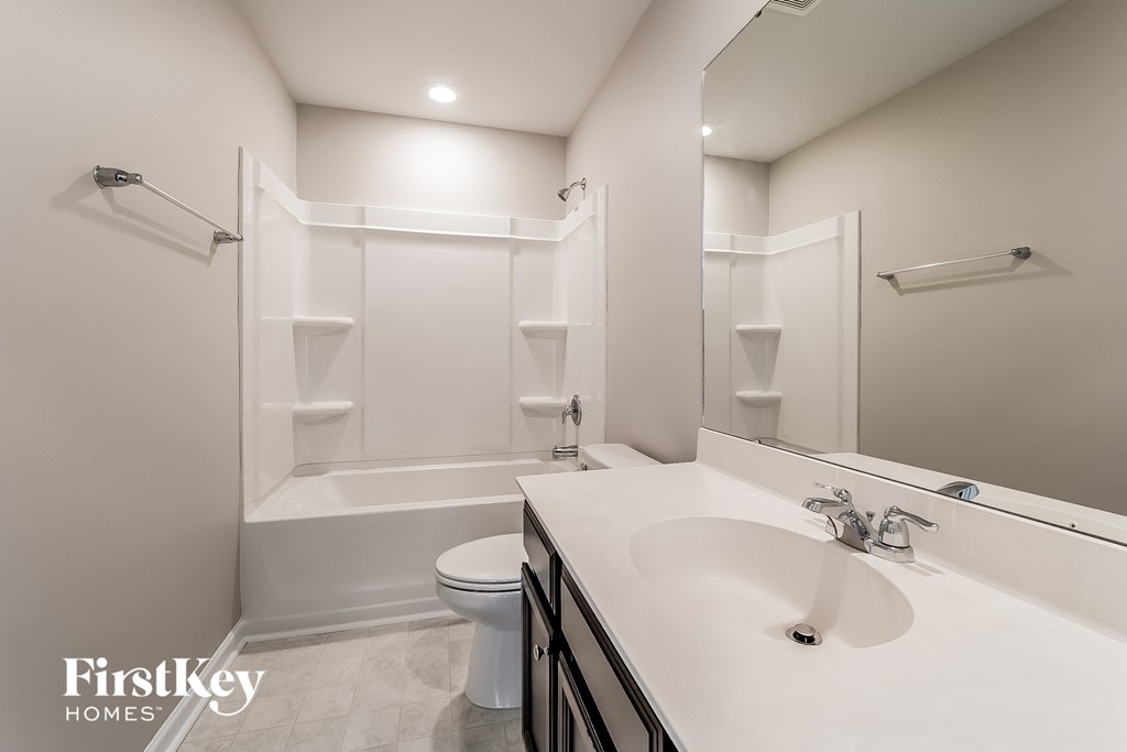 a bathroom with a sink and a toilet and a bath tub