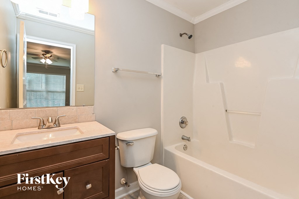 a bathroom with a toilet and a sink and a bath tub