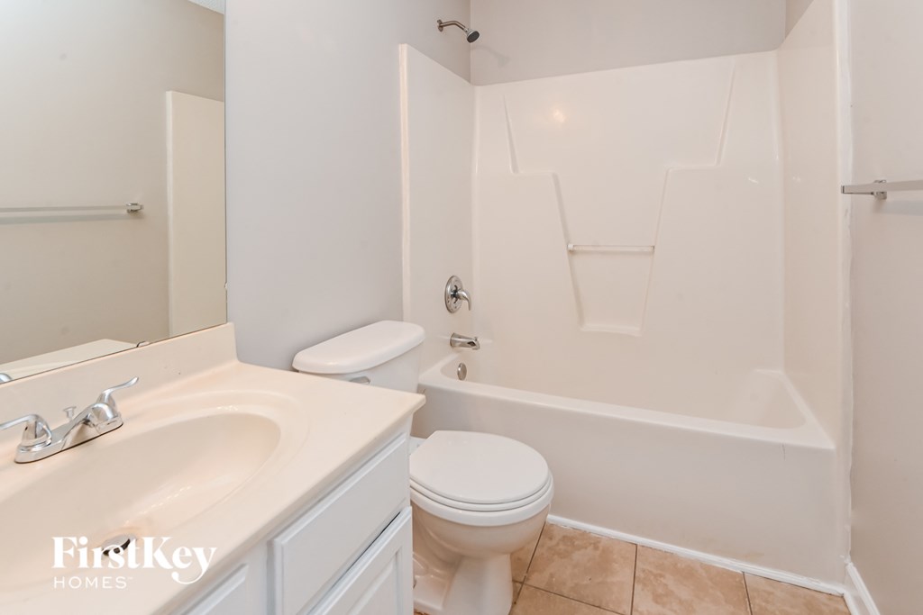 a bathroom with a sink toilet and a bath tub