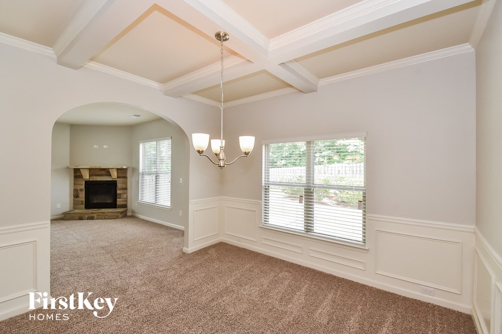a living room with a fireplace and a large window
