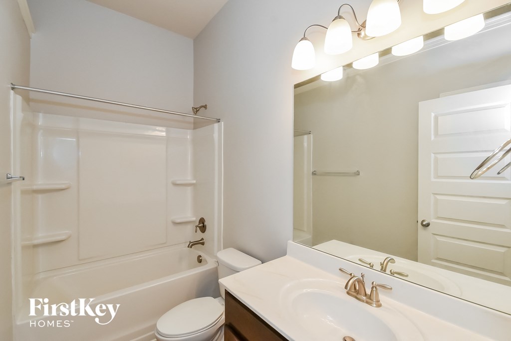 a bathroom with a sink and a tub and a mirror