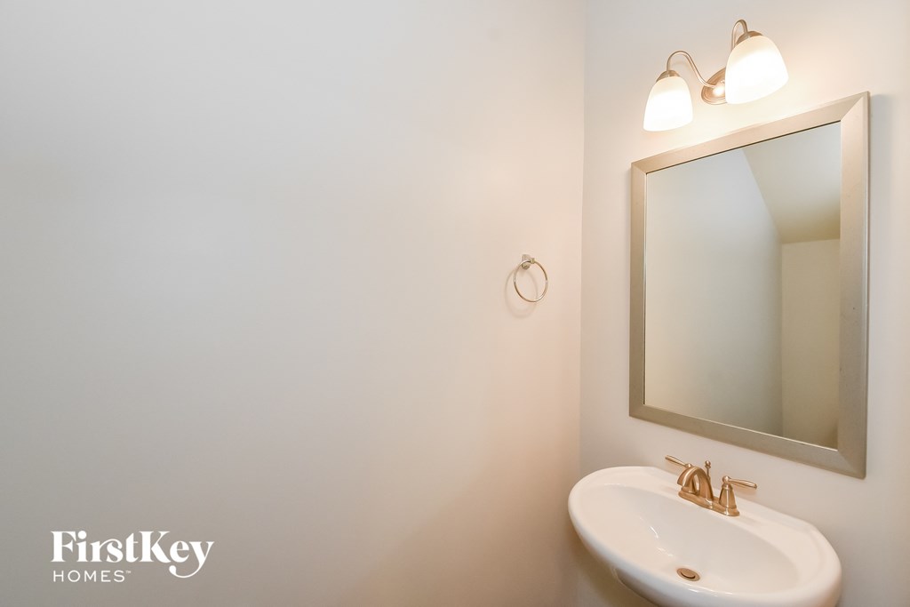a small bathroom with a sink and a mirror