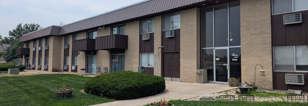 A building with brown and beige exterior and a black roof.