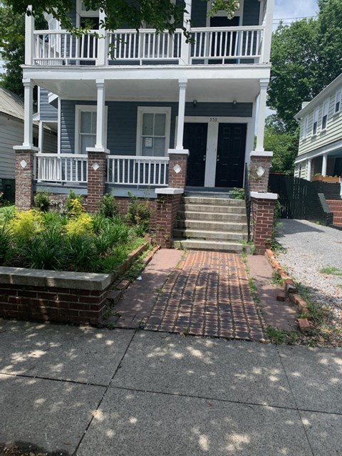 a house with a porch and stairs in front of it