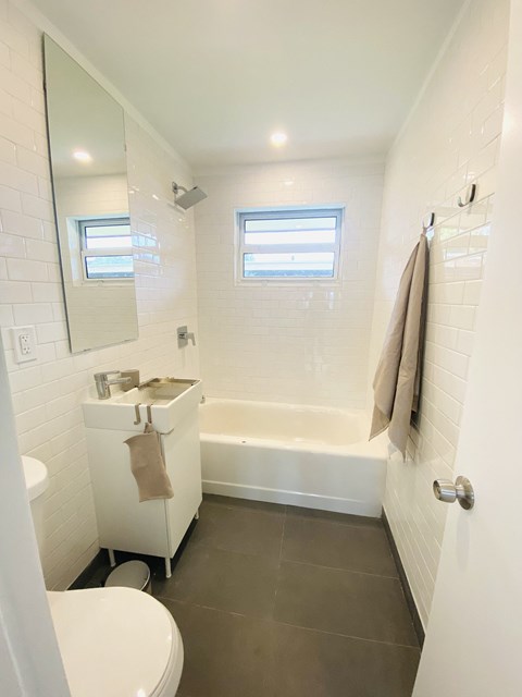 a small bathroom with a sink and a bath tub