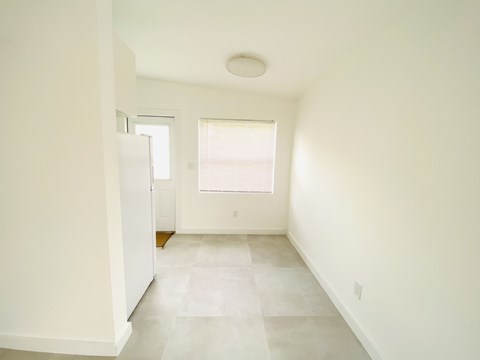 an empty room with white walls and a window