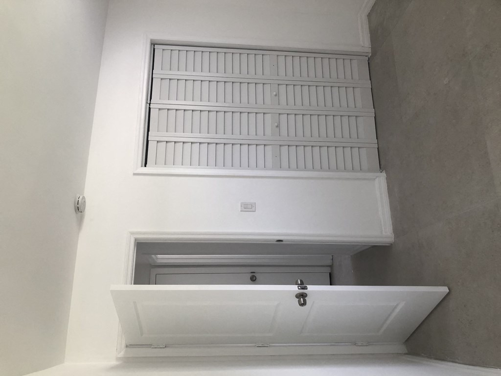 a white bath tub sitting under a window in a room