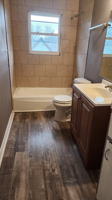a bathroom with a toilet and a bath tub