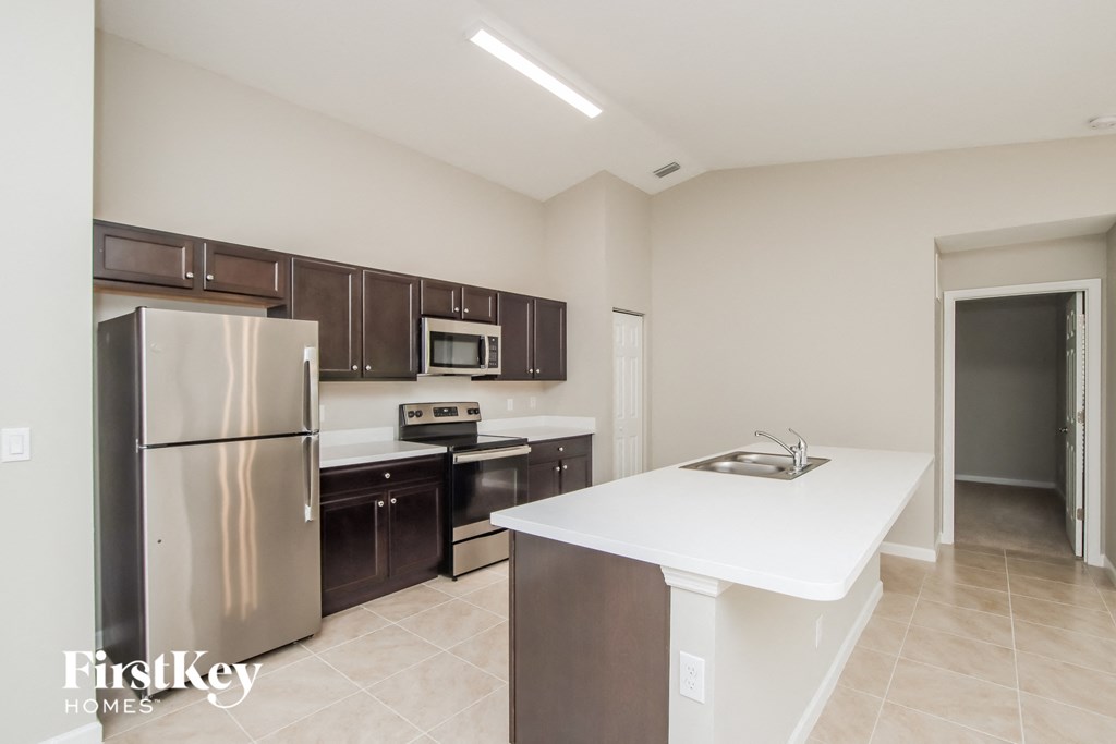 a kitchen with stainless steel appliances and a white counter top