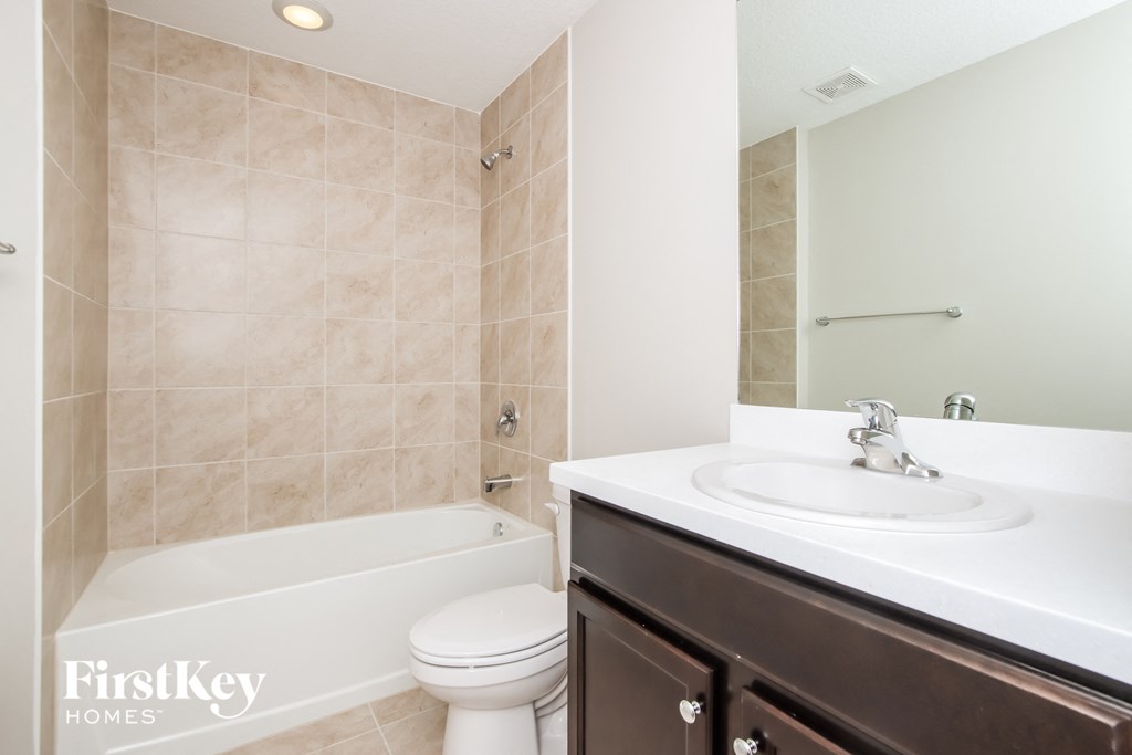 a bathroom with a sink and a toilet and a bath tub