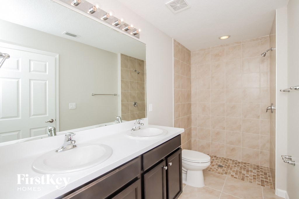 a bathroom with a toilet and a sink and a mirror