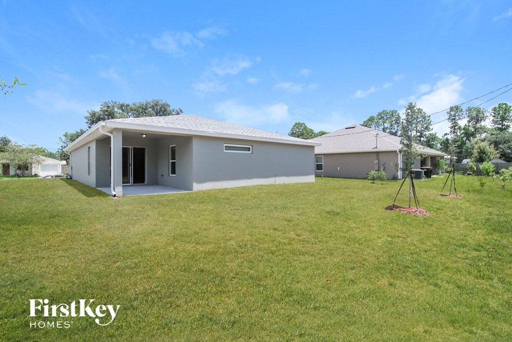 a home with a lawn and a house in the background