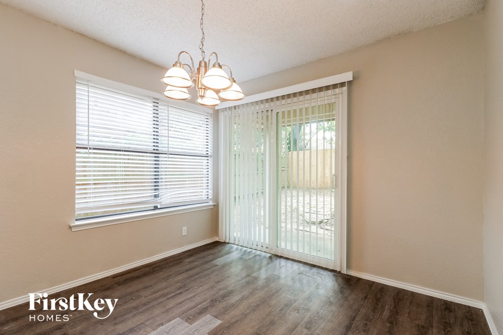 a living room with a sliding glass door and a window