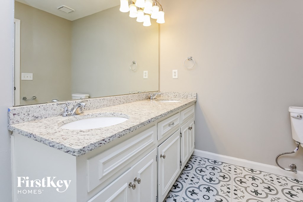 a white bathroom with a sink and a mirror