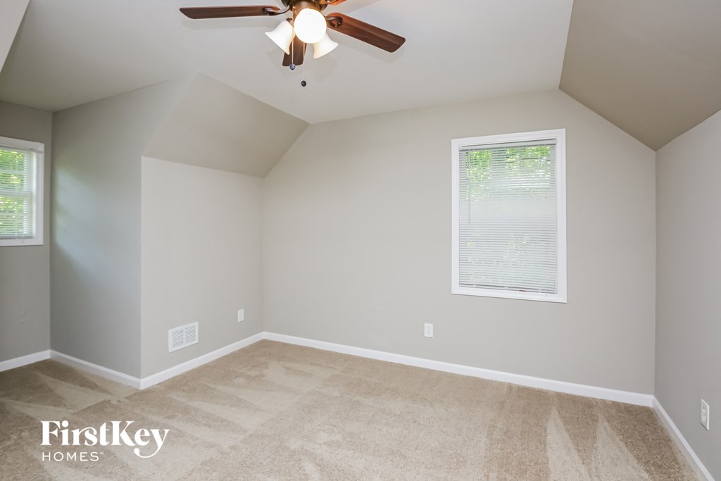 the second bedroom is spacious and has a ceiling fan