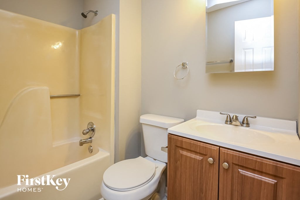 a bathroom with a toilet and a sink and a bath tub