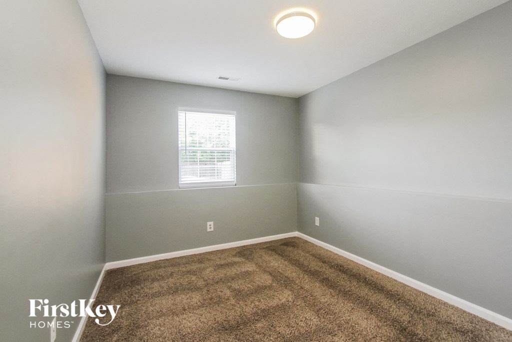a room with a carpeted floor and a window