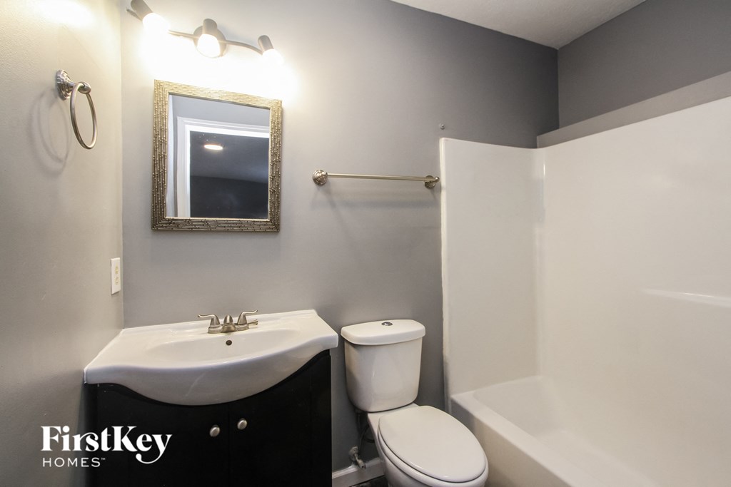 a bathroom with a sink toilet and a shower