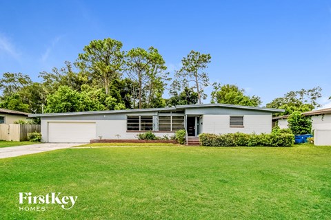 a white house with a lawn in front of it