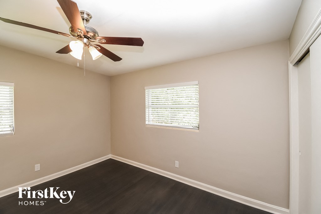 a living room with a ceiling fan and a window