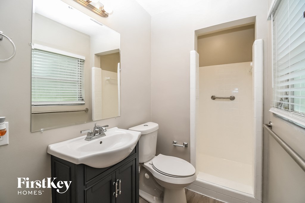 a bathroom with a sink toilet and a shower
