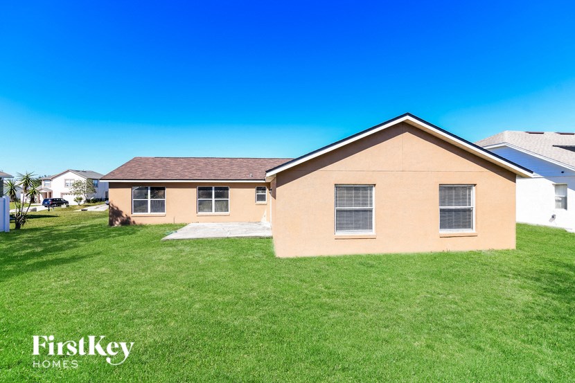 a home with a yard and a house with grass