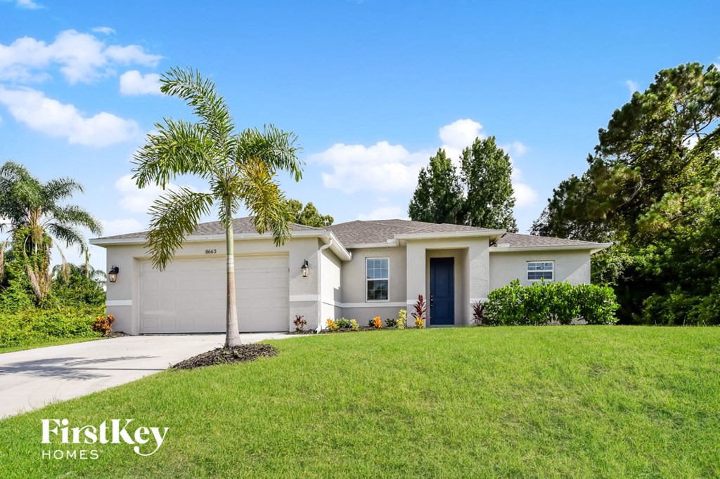 A house with a palm tree in front of it.