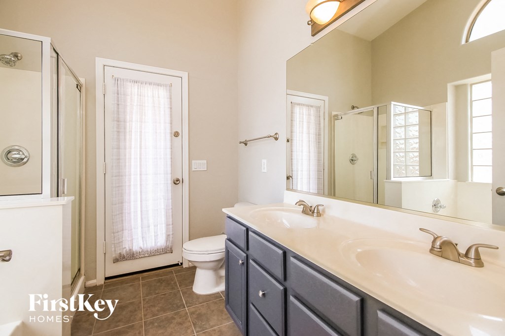 a bathroom with a sink and a toilet and a shower