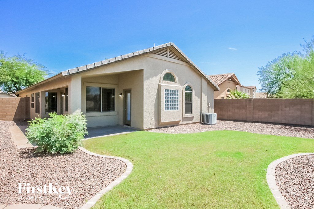 a home with a yard and a lawn and a fence