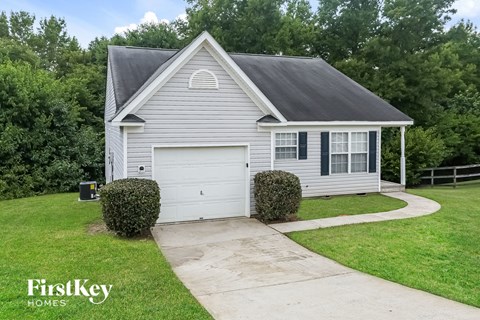 A house with a garage and a driveway is for sale.